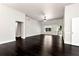 Spacious living room with dark wood floors, a ceiling fan, and large windows, providing a bright and airy atmosphere at 960 River Valley Dr, Dacula, GA 30019