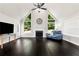 Bright living room featuring high ceilings, a cozy fireplace, and large windows with outdoor views at 960 River Valley Dr, Dacula, GA 30019
