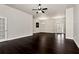 Expansive living room featuring dark wood floors, elegant chandeliers, and ample space for entertaining at 960 River Valley Dr, Dacula, GA 30019