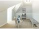 Attic sitting area with white wainscoting, decor, and two armchairs at 120 Kettering Trce, Tyrone, GA 30290