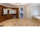 Spacious bathroom featuring custom wood cabinets, double sinks, granite counters, and a large tiled floor at 120 Kettering Trce, Tyrone, GA 30290