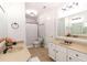 Bright bathroom featuring dual sinks, tan countertops, and a shower-tub combination at 120 Kettering Trce, Tyrone, GA 30290