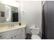 Modern bathroom with white vanity, toilet, and shower with gray and black curtain at 120 Kettering Trce, Tyrone, GA 30290