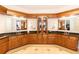 Luxurious bathroom with double vanity, granite countertops, dark wood cabinets, and decorative tile floor at 120 Kettering Trce, Tyrone, GA 30290