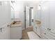 White bathroom with dual sinks and a neutral tile floor at 120 Kettering Trce, Tyrone, GA 30290