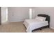Neutral bedroom featuring carpeted floors, gray headboard, and an ensuite bathroom at 120 Kettering Trce, Tyrone, GA 30290