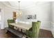 Dining room featuring hardwood floors, decorative light fixture, and modern decor at 120 Kettering Trce, Tyrone, GA 30290