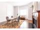 Modern dining room with natural light, fireplace, and seating for four at 120 Kettering Trce, Tyrone, GA 30290