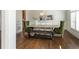 Dining room with hardwood floors, decorative light fixture, and modern decor at 120 Kettering Trce, Tyrone, GA 30290