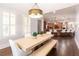 Dining room with a farmhouse-style table and views into the kitchen at 120 Kettering Trce, Tyrone, GA 30290