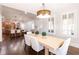 Sunlit dining room with hardwood floors and views into the kitchen at 120 Kettering Trce, Tyrone, GA 30290