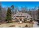 Stately brick home featuring lush landscaping, mature trees, and a circular driveway on a sprawling lot at 120 Kettering Trce, Tyrone, GA 30290