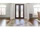 Elegant foyer featuring decorative iron double doors, tiled floors, and views of bright, shuttered windows at 120 Kettering Trce, Tyrone, GA 30290