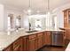 Kitchen view showing granite countertops, custom cabinets, and stainless steel dishwasher at 120 Kettering Trce, Tyrone, GA 30290