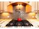 Beautiful kitchen detail highlighting the gas cooktop and custom backsplash at 120 Kettering Trce, Tyrone, GA 30290