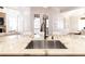 Bright kitchen features granite countertops, a stainless steel sink, and white cabinets at 120 Kettering Trce, Tyrone, GA 30290
