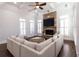 Bright living room with a stone fireplace and large sectional sofa at 120 Kettering Trce, Tyrone, GA 30290