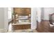 Inviting living room with hardwood floors, accent wall, and plush seating arrangements at 120 Kettering Trce, Tyrone, GA 30290