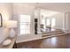 An open concept living room with hardwood flooring, columns and many windows at 120 Kettering Trce, Tyrone, GA 30290