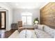 Comfortable living room featuring a decorative accent wall, neutral tones, and an abundance of natural light at 120 Kettering Trce, Tyrone, GA 30290