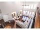 Open living room view from above featuring fireplace, sofa, and plenty of natural light at 120 Kettering Trce, Tyrone, GA 30290