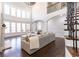 Spacious living room with large windows, hardwood floors, and comfortable seating area at 120 Kettering Trce, Tyrone, GA 30290