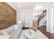 Well-appointed living room showcasing wood accent wall, stylish furniture, and staircase access at 120 Kettering Trce, Tyrone, GA 30290