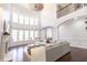 Living room with large windows, hardwood floors, and comfortable seating area at 120 Kettering Trce, Tyrone, GA 30290