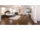 Large main bedroom with tray ceiling, hardwood floors, lounge area, beverage center, and king bed at 120 Kettering Trce, Tyrone, GA 30290