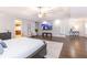 Spacious main bedroom boasts a television, beverage center, lounge area, coffered ceiling, and king bed at 120 Kettering Trce, Tyrone, GA 30290
