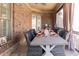Outdoor dining area with wicker chairs and a stone table at 120 Kettering Trce, Tyrone, GA 30290