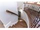 Elegant curved staircase with wood treads and wrought iron railing leads to upper level at 120 Kettering Trce, Tyrone, GA 30290