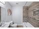 Modern bathroom featuring decorative tiling, bathtub with shower, and minimalist design for a spa-like experience at 1482 Andrews Nw St, Atlanta, GA 30314