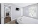 Serene bedroom with clean, neutral colors, soft carpet, TV, and ample natural light, creating a peaceful retreat at 1482 Andrews Nw St, Atlanta, GA 30314