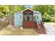 Charming blue home with a cozy front porch and wooden stairs leading to the entrance at 1482 Andrews Nw St, Atlanta, GA 30314
