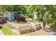 Landscaped front yard with a charming blue home, fenced yard, and inviting curb appeal at 1482 Andrews Nw St, Atlanta, GA 30314