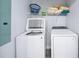 Functional laundry area featuring a washer, dryer, and convenient storage shelves at 1482 Andrews Nw St, Atlanta, GA 30314