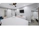 Bright main bedroom with sliding barn door to closet, modern fan, and neutral colors at 1482 Andrews Nw St, Atlanta, GA 30314
