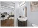 Stylish powder room with a modern vanity, sleek fixtures, and seamless transition into an open-concept kitchen and living area at 1482 Andrews Nw St, Atlanta, GA 30314