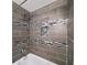 Modern tiled shower with decorative tiles, built-in niche, and sleek fixtures for a luxurious bathing experience at 1482 Andrews Nw St, Atlanta, GA 30314