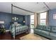 Bedroom featuring a bed with a metal frame, city views, and an adjacent seating area at 375 Ralph Mcgill Ne Blvd # 1701, Atlanta, GA 30312