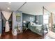 Bedroom features a bed with a metal frame, hardwood floors, and charming decor at 375 Ralph Mcgill Ne Blvd # 1701, Atlanta, GA 30312
