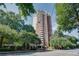 Stately high rise condominium building with a brick facade and a covered entrance at 375 Ralph Mcgill Ne Blvd # 1701, Atlanta, GA 30312