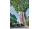 High rise condominium with red brick facade, canopy covered entrance, and lush greenery at 375 Ralph Mcgill Ne Blvd # 1701, Atlanta, GA 30312