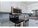 Kitchen featuring white cabinets, stainless steel appliances, and granite countertops at 375 Ralph Mcgill Ne Blvd # 1701, Atlanta, GA 30312