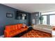 Living room featuring stylish sofas, a large television, and an orange patterned rug at 375 Ralph Mcgill Ne Blvd # 1701, Atlanta, GA 30312