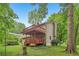 Two-story back deck, surrounded by mature trees, adds outdoor living space to this home at 497 Fire Fly Dr, Tucker, GA 30084
