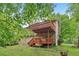 Lush backyard with two-story deck that enhances the exterior of the home at 497 Fire Fly Dr, Tucker, GA 30084