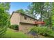 Exterior of home featuring two-story back deck surrounded by mature trees and lush greenery at 497 Fire Fly Dr, Tucker, GA 30084