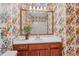 Bathroom with tub, shower, wood vanity, and floral wallpaper at 497 Fire Fly Dr, Tucker, GA 30084